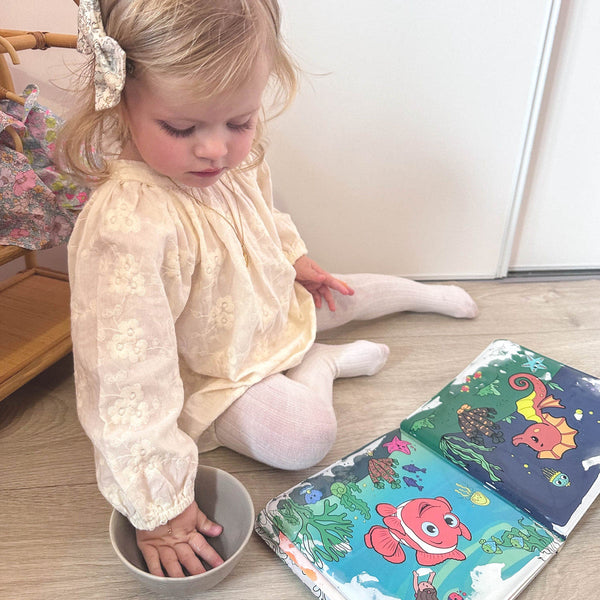 Child dipping the pen in water