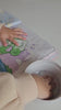 Toddler painting with water and a finger
